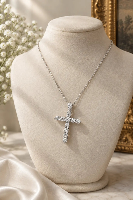 Diamond cross necklace in 18K white gold on an ivory velvet bust