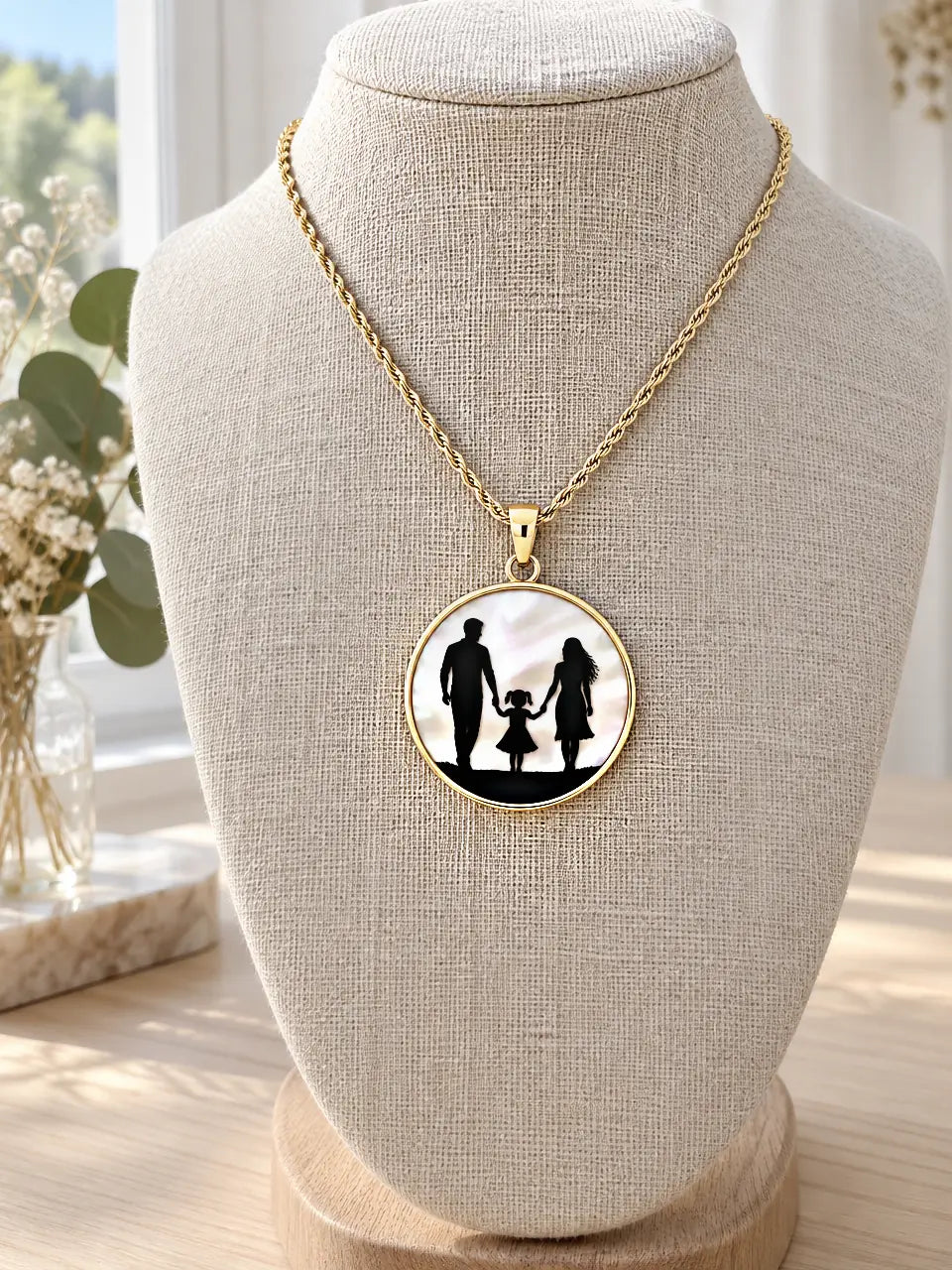 Family silhouette pendant necklace: black family walking hand in hand on white mother-of-pearl, 14K gold