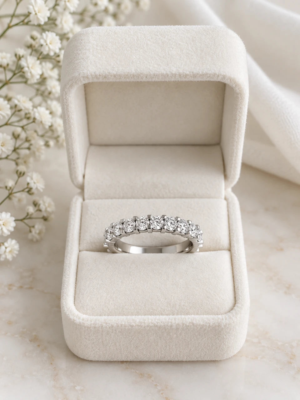 Half eternity ring in white gold with round diamonds, in a cream velvet box
