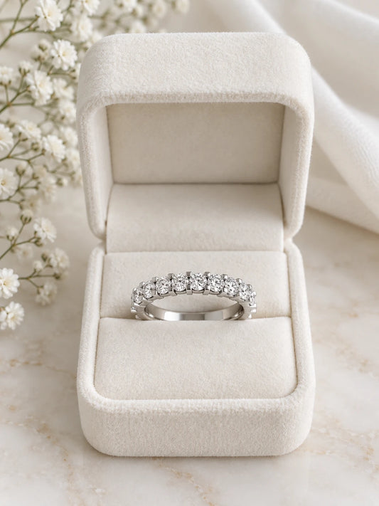 Half eternity ring in white gold with round diamonds, in a cream velvet box