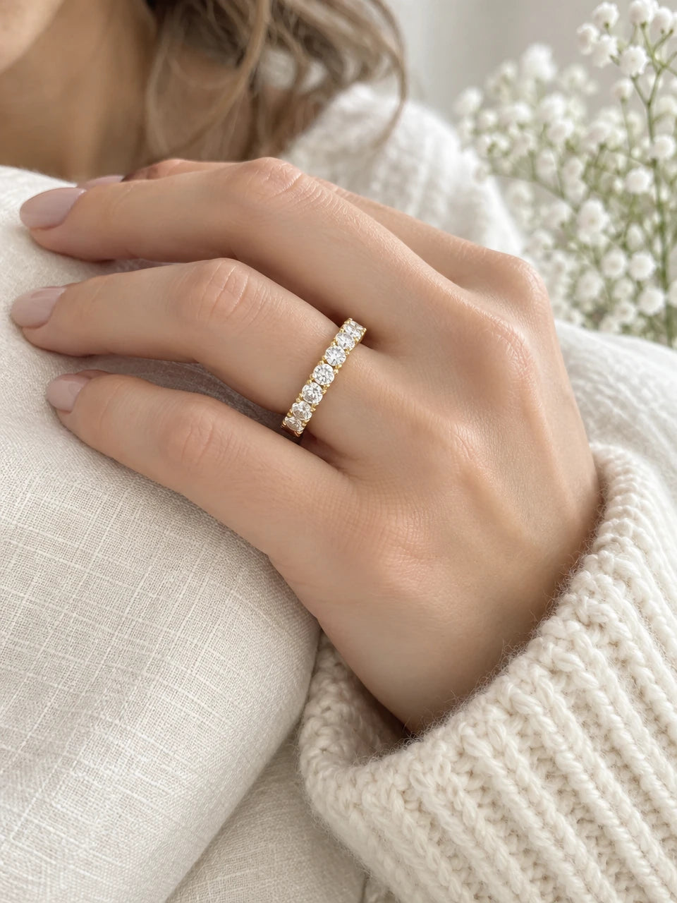 Yellow gold eternity band for women worn on a hand