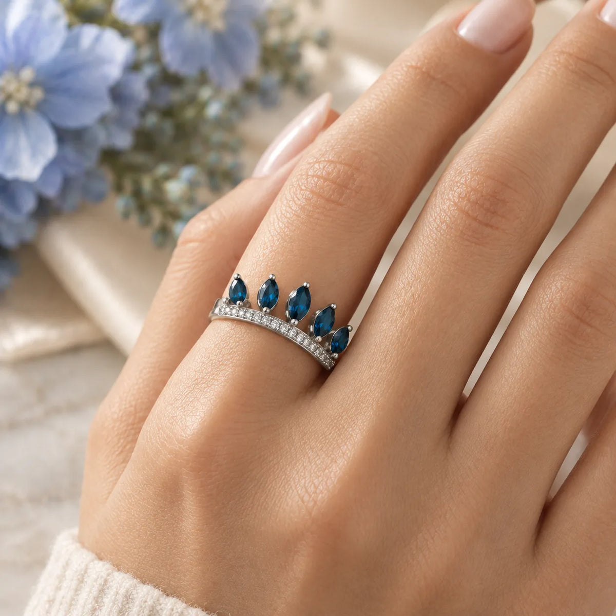 London blue topaz ring in white gold with a pavé diamond band, worn alone