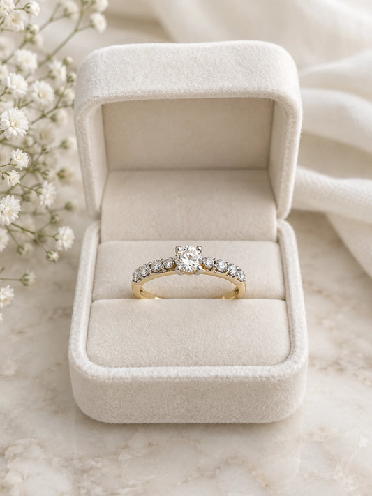 Two-tone mixed metal engagement ring with a round diamond, yellow gold band, in a cream velvet box