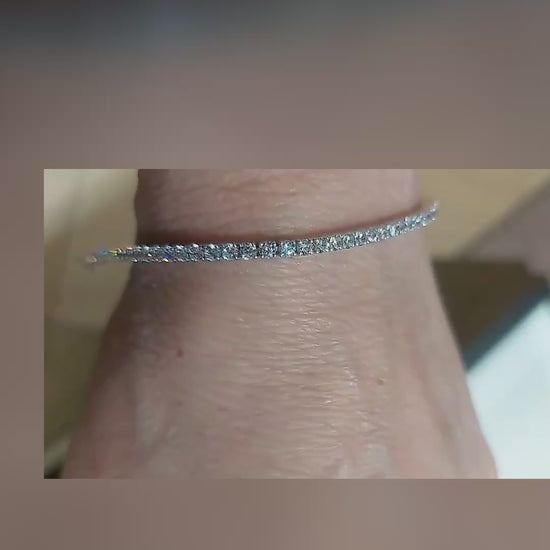 Close-up video of the white gold diamond tennis bracelet on a wrist, showing the single line of diamonds