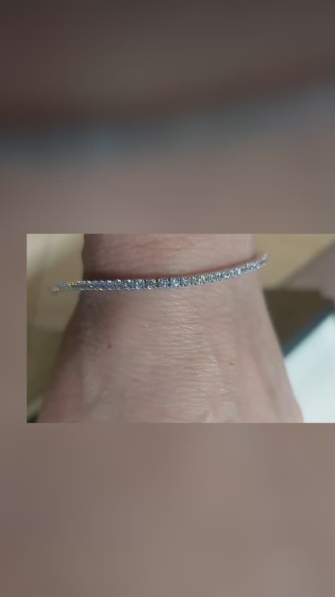 Close-up video of the white gold diamond tennis bracelet on a wrist, showing the single line of diamonds