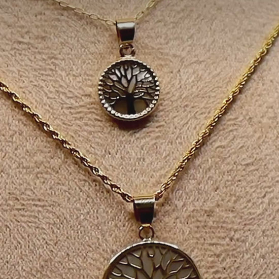 Close-up video of the 14K yellow gold Tree of Life pendant necklaces on a display bust