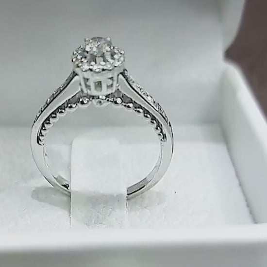 Close-up video of the 14K white gold hidden halo engagement ring, with diamonds tucked under the centre stone