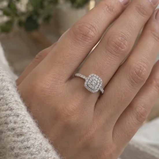 Video of the double halo cushion cut engagement ring in 14K gold worn on a woman's hand, showing both rows of pavé diamonds
