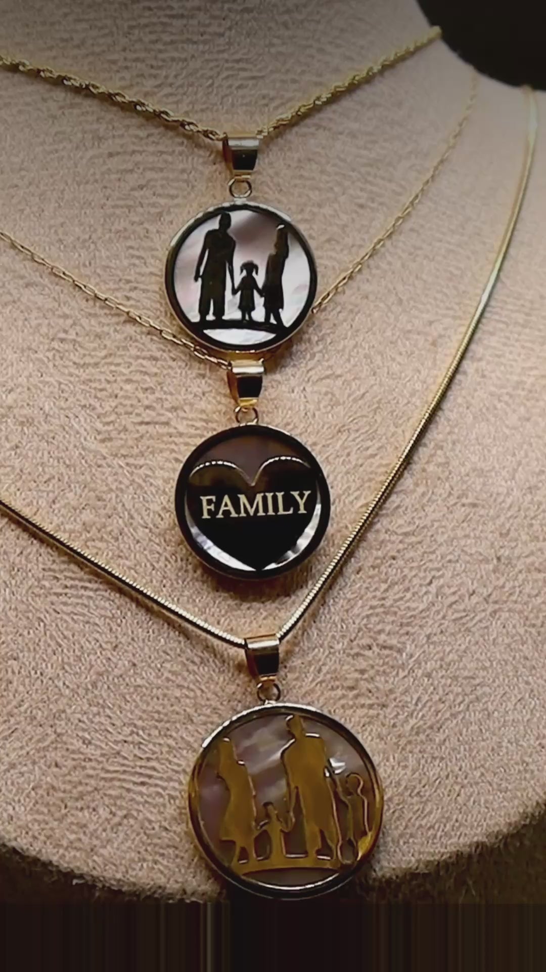 Close-up video of three GH Jewells family pendant necklaces in 14K gold and mother-of-pearl