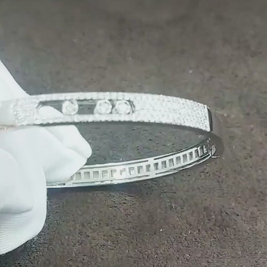 Close-up video of the pavé diamond bangle with three sliding diamonds (shown in white gold; same design in yellow gold)