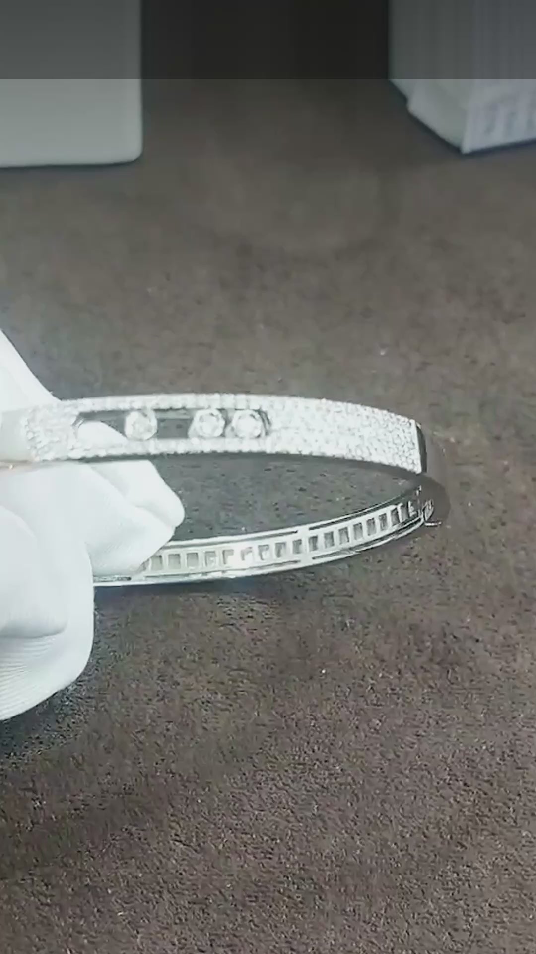 Close-up video of the pavé diamond bangle with three sliding diamonds (shown in white gold; same design in yellow gold)