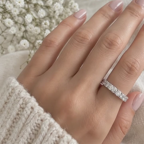 Half eternity ring in 14K white gold with round diamonds, worn on a hand