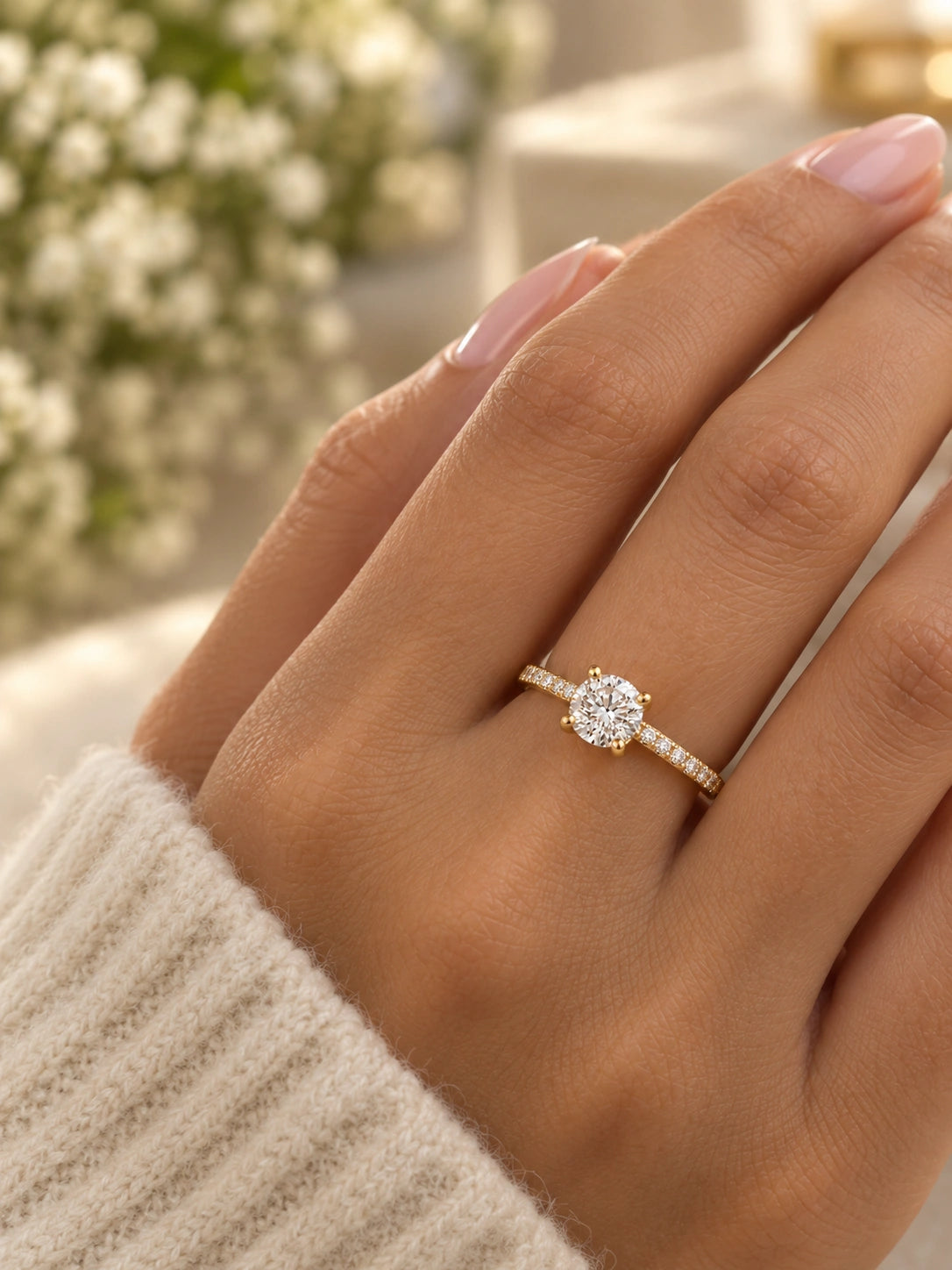 Round solitaire engagement ring in 14K yellow gold worn on a hand to show its size