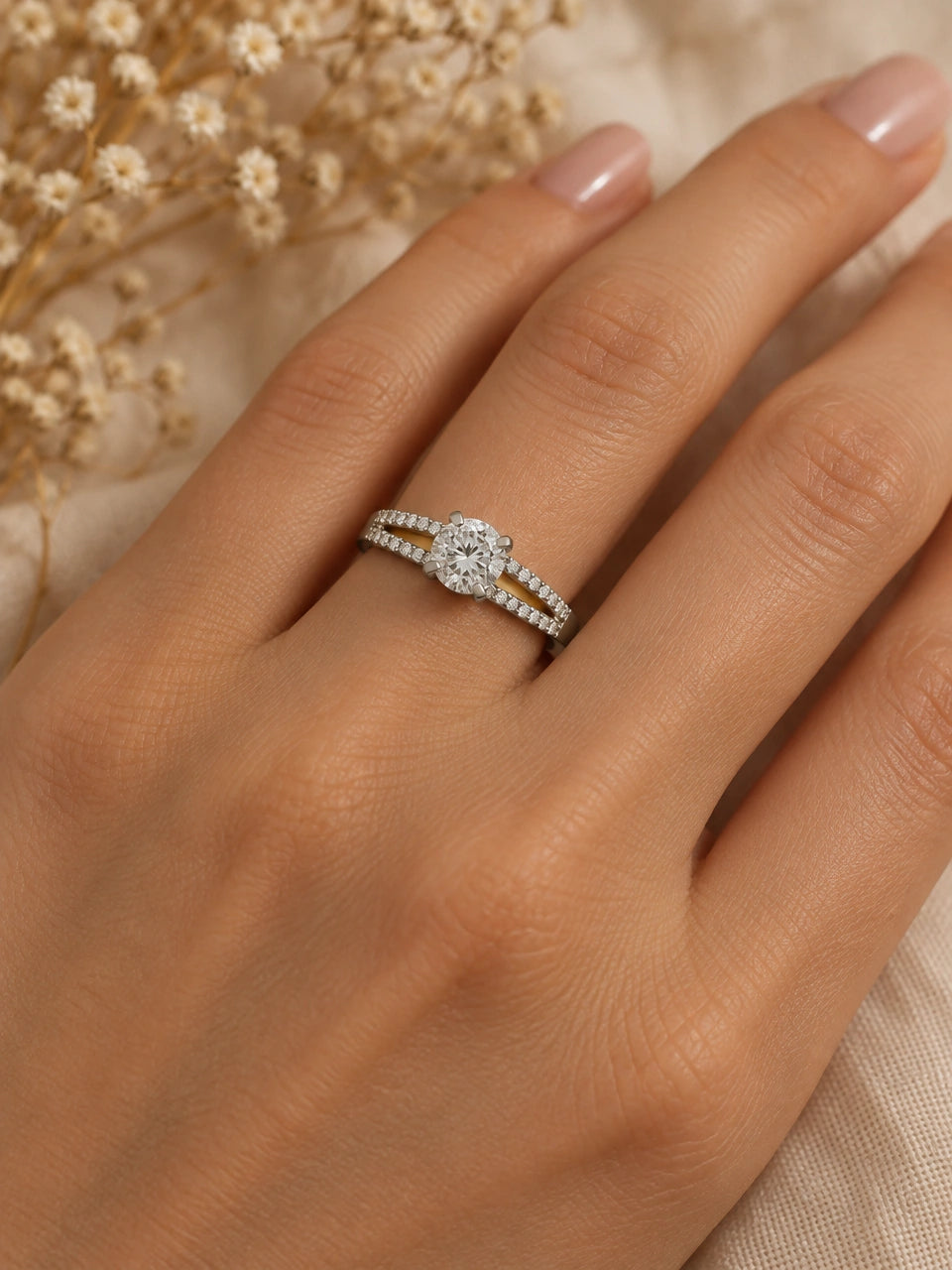 Split shank diamond engagement ring worn on a woman's ring finger