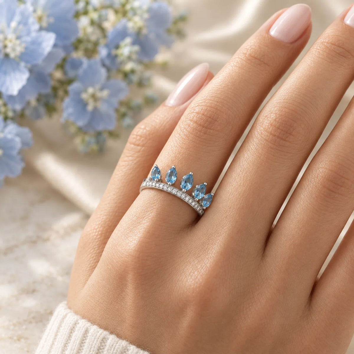 Swiss blue topaz ring in white gold with a pavé diamond band, worn alone