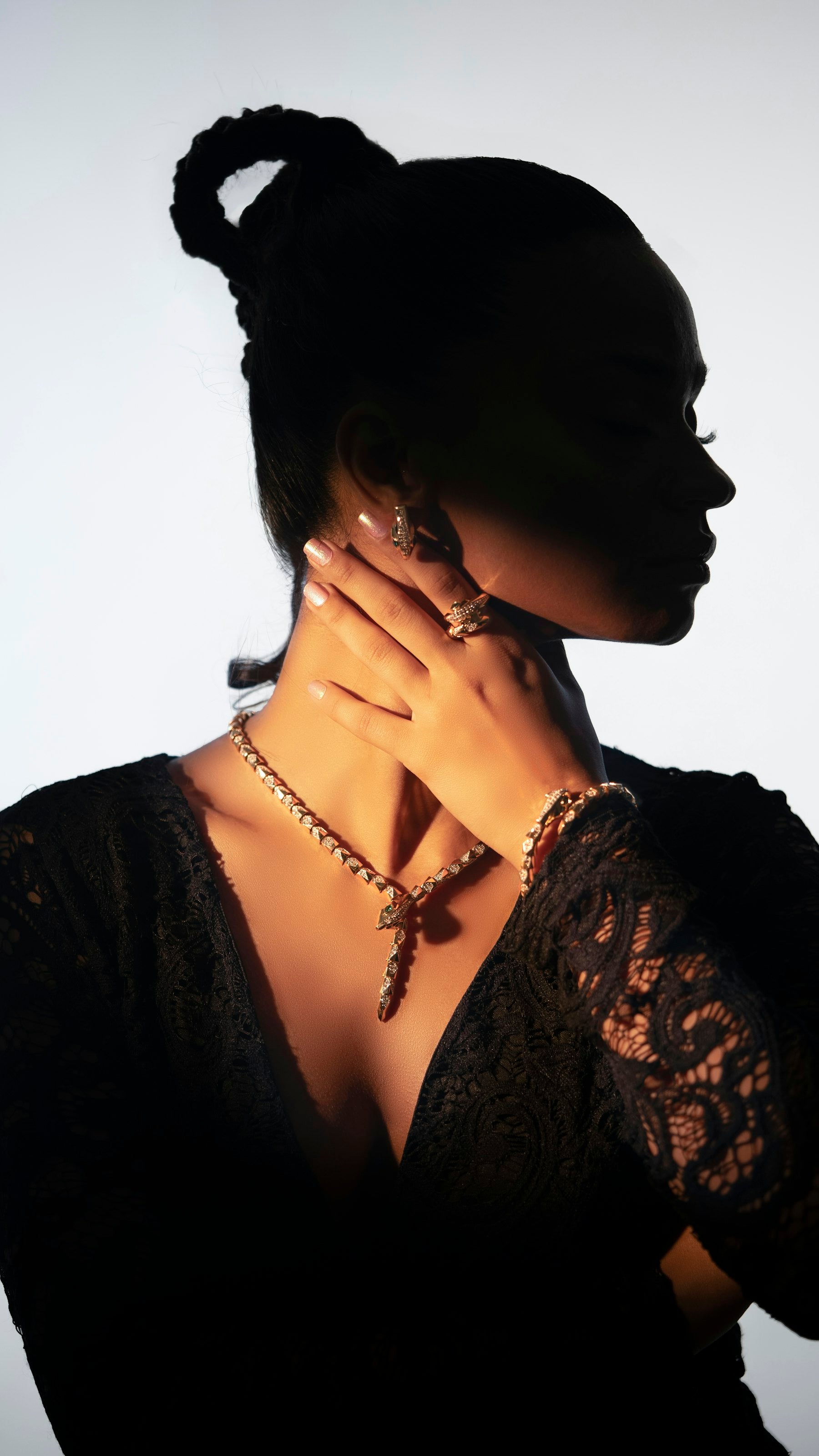 Model wearing statement gold jewellery